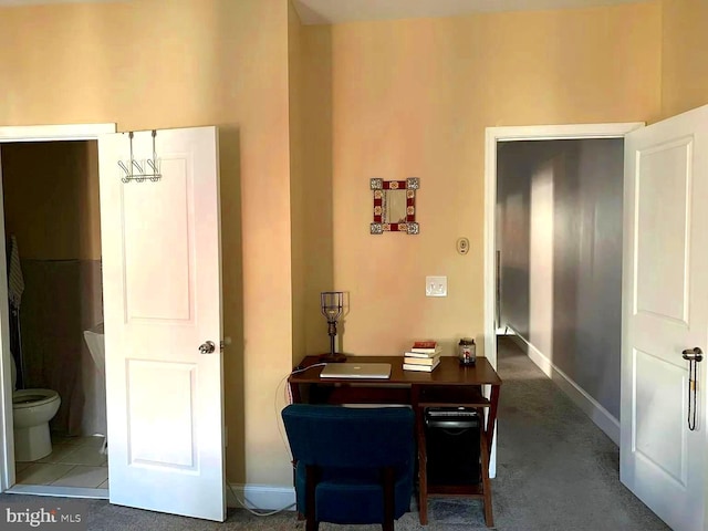 home office featuring dark colored carpet