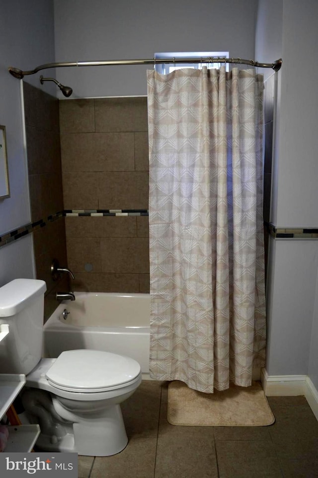 bathroom featuring tile patterned floors, shower / bath combo, and toilet