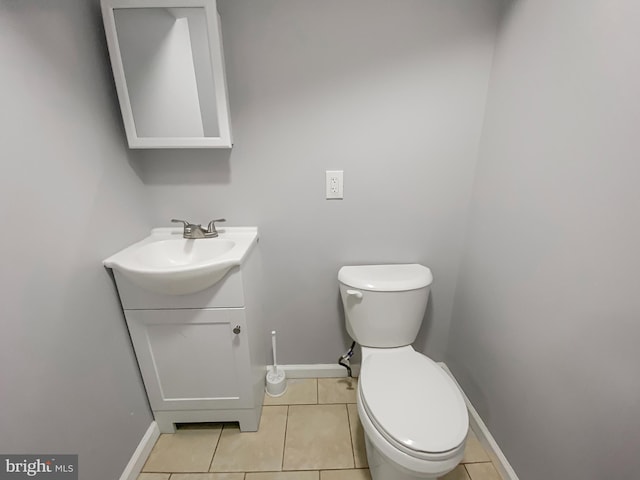 bathroom featuring tile patterned flooring, vanity, and toilet