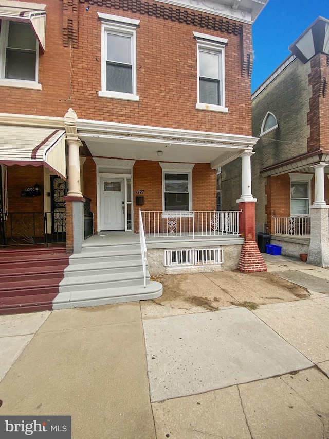 townhome / multi-family property with a porch