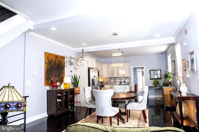 dining area with dark hardwood / wood-style floors and ornamental molding