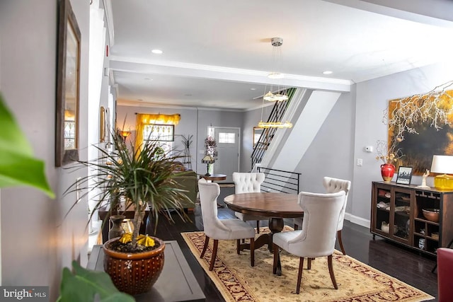 dining space with dark hardwood / wood-style floors and ornamental molding