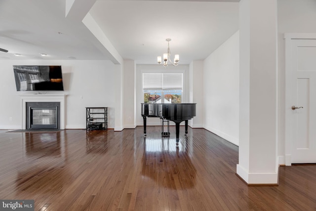 miscellaneous room with a notable chandelier and dark hardwood / wood-style flooring