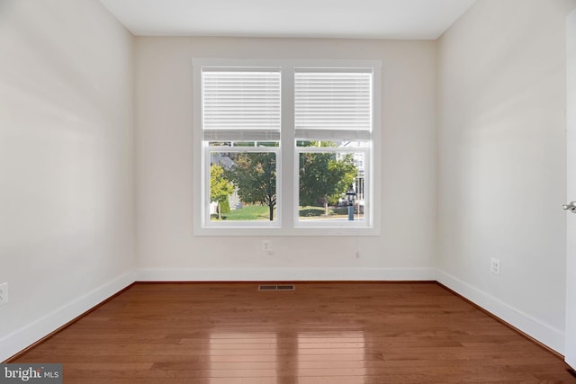 spare room with hardwood / wood-style floors