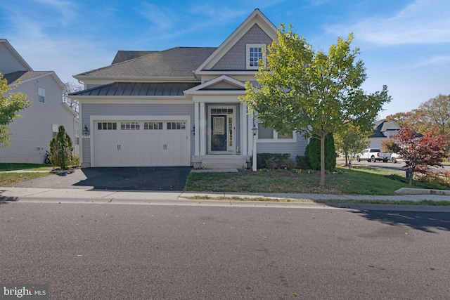 view of front of property featuring a front yard and a garage