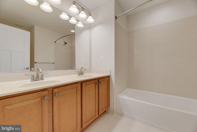 bathroom featuring vanity, tiled shower / bath combo, and tile patterned flooring