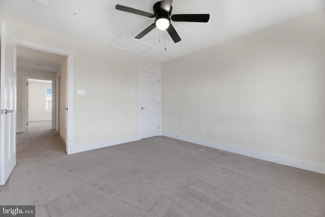 carpeted spare room with ceiling fan