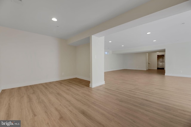 basement with light hardwood / wood-style floors