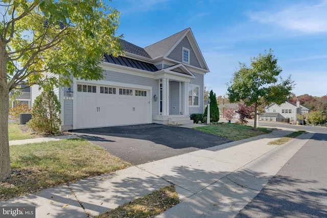 view of front of property featuring a front yard and a garage