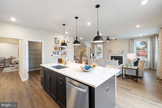 kitchen with a center island with sink, a healthy amount of sunlight, and dishwasher