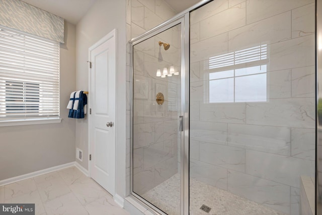 bathroom with a shower with door