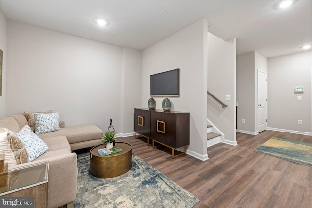 living room with dark hardwood / wood-style flooring