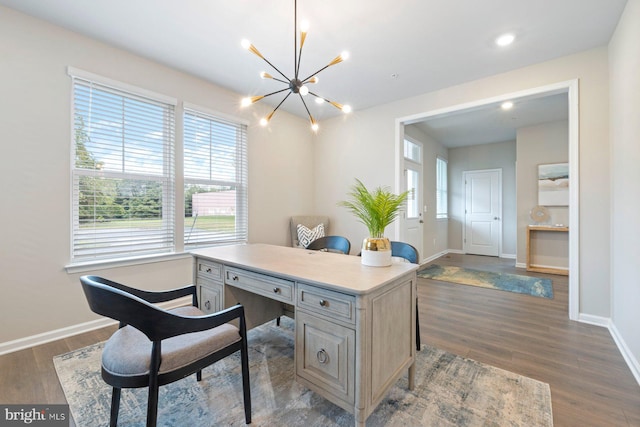 office space with an inviting chandelier and dark hardwood / wood-style flooring