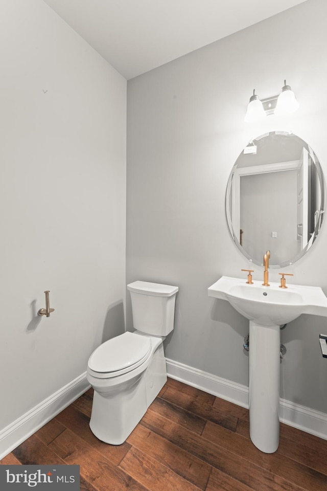 bathroom with wood-type flooring and toilet