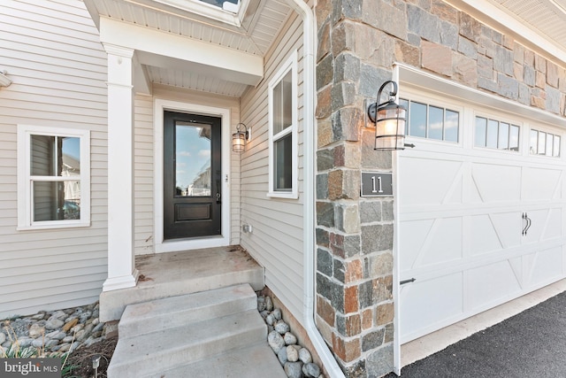 doorway to property with a garage