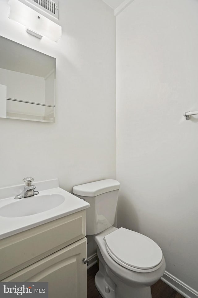 bathroom featuring vanity and toilet