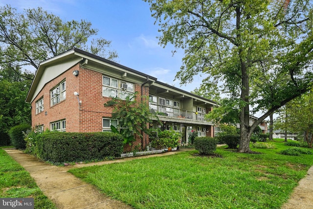 view of property exterior featuring a yard and a balcony