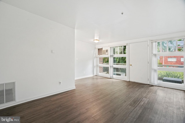 unfurnished living room featuring dark hardwood / wood-style flooring