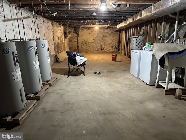 basement with washing machine and clothes dryer and electric water heater