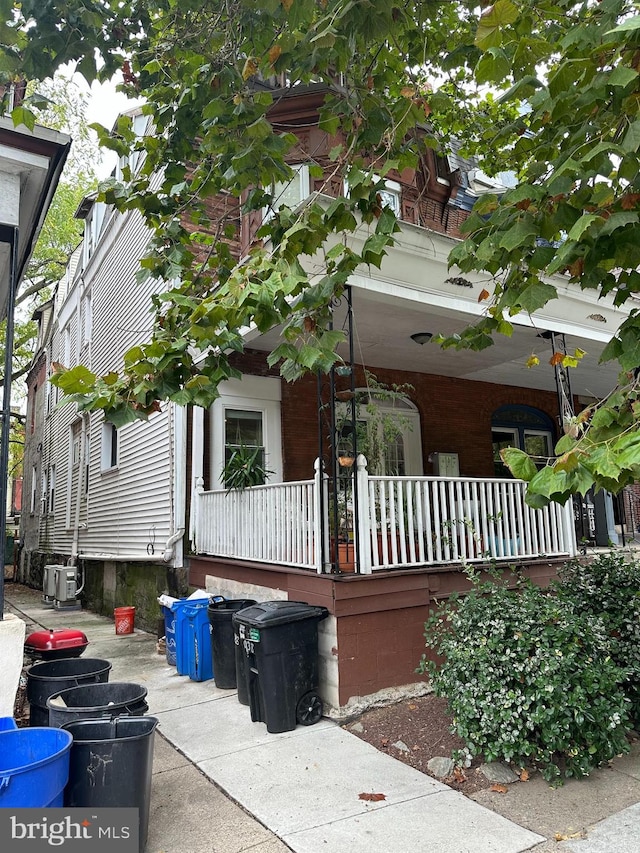 view of side of property with covered porch