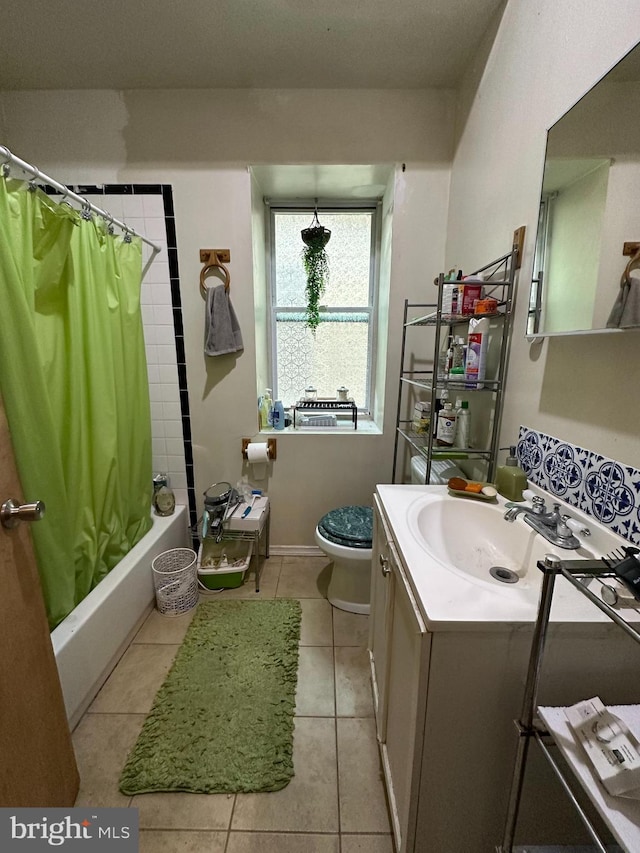 full bathroom featuring shower / tub combo with curtain, vanity, toilet, and tile patterned floors