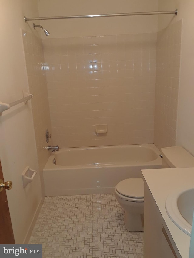 full bathroom with vanity, tiled shower / bath combo, toilet, and tile patterned floors