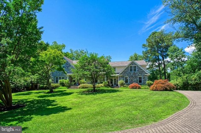 obstructed view of property with a front lawn