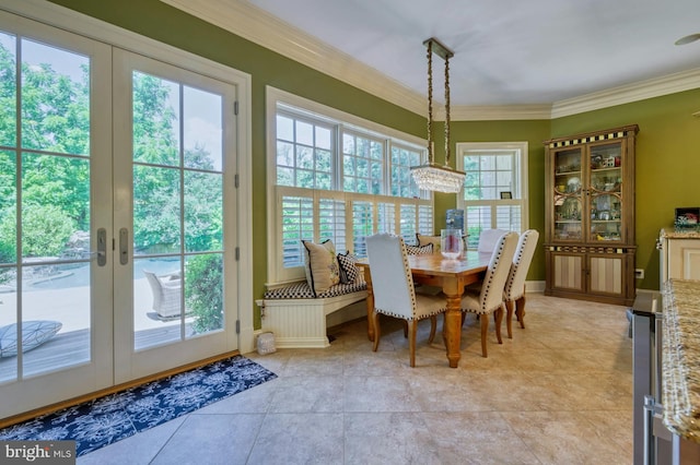 dining area with ornamental molding and french doors