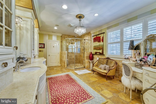 bathroom with a shower with door, crown molding, vanity, and a chandelier