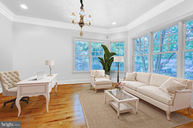 living room featuring crown molding, an inviting chandelier, and light wood-type flooring