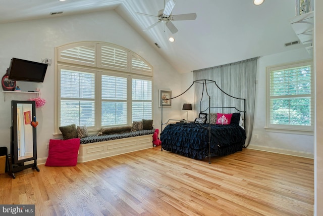 bedroom with ceiling fan, hardwood / wood-style floors, and high vaulted ceiling