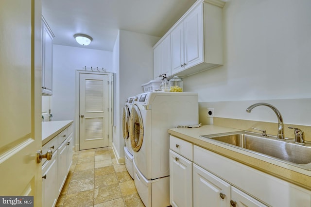 laundry area featuring cabinets, sink, and washing machine and dryer