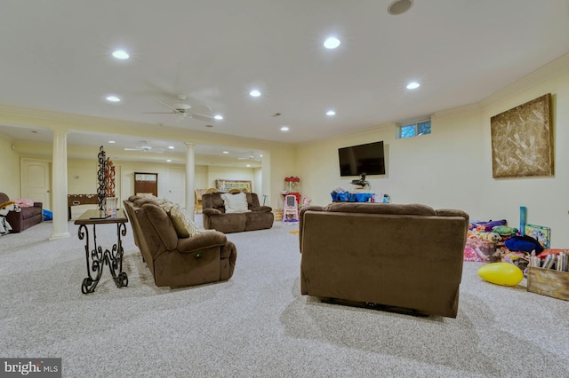 carpeted living room with ornamental molding, ceiling fan, and ornate columns