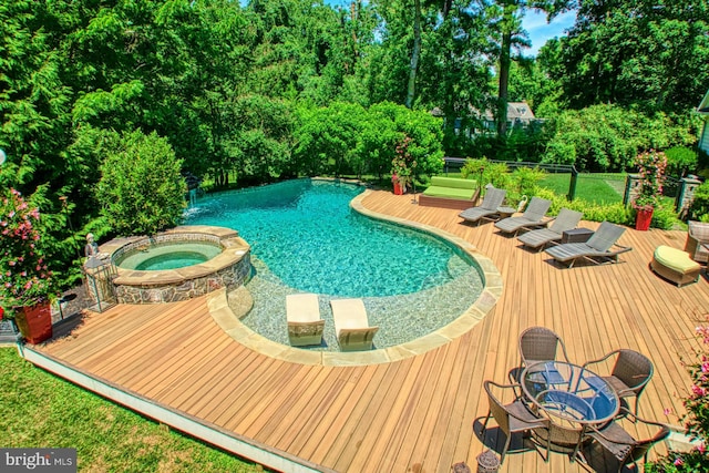 view of pool featuring an in ground hot tub and a deck