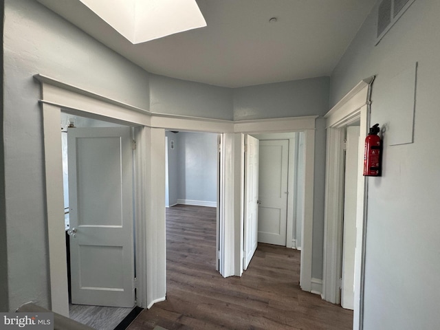 corridor featuring dark hardwood / wood-style flooring