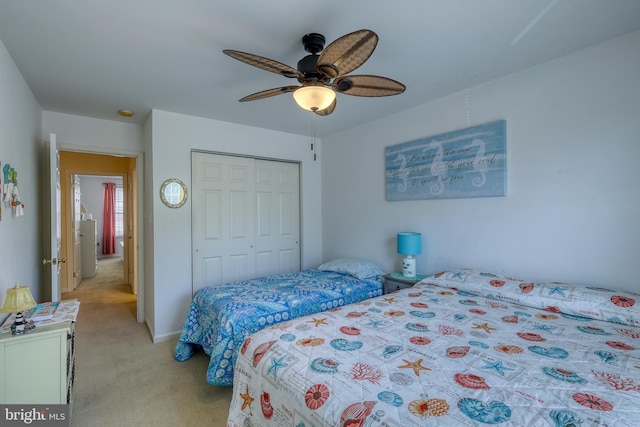 carpeted bedroom featuring ceiling fan and a closet