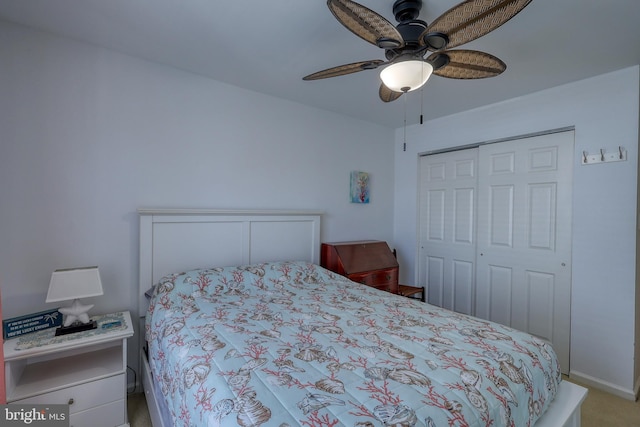 carpeted bedroom featuring ceiling fan and a closet