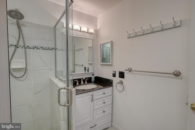 bathroom with vanity and a shower with shower door