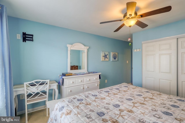 carpeted bedroom with ceiling fan and a closet