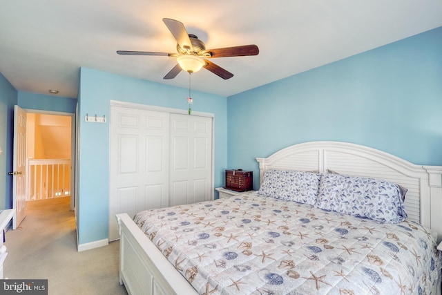 carpeted bedroom featuring ceiling fan and a closet