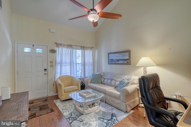 living room with light wood-type flooring, ceiling fan, and high vaulted ceiling