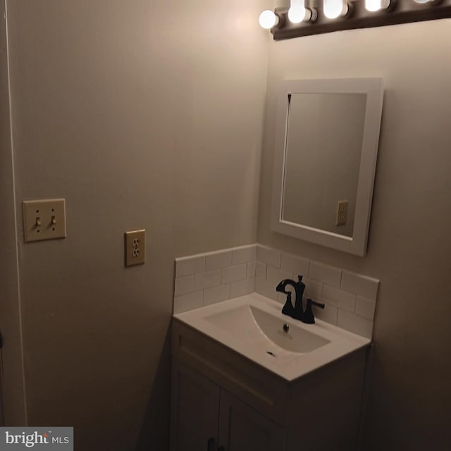 bathroom with decorative backsplash and vanity