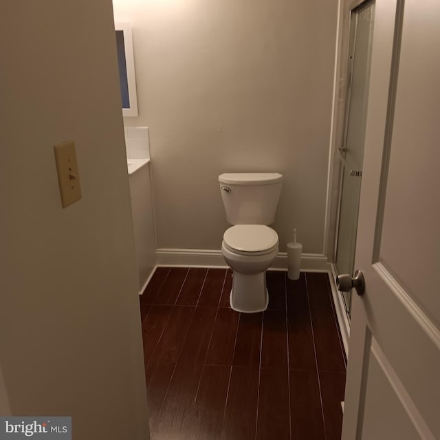 bathroom featuring wood-type flooring, vanity, and toilet