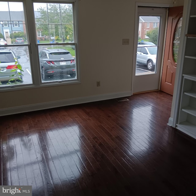 unfurnished room featuring dark hardwood / wood-style floors