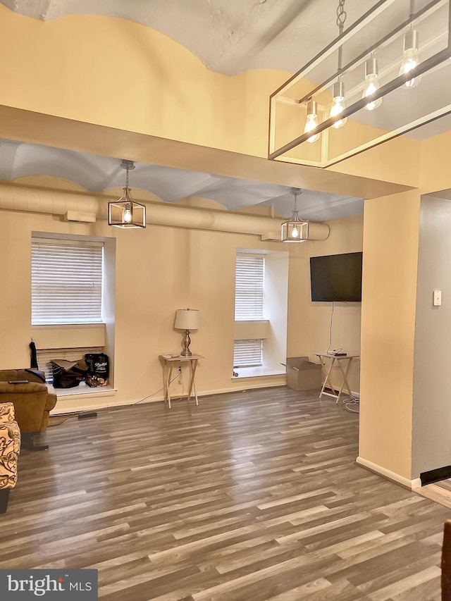 interior space featuring hardwood / wood-style flooring and a high ceiling