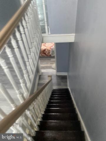 staircase featuring hardwood / wood-style floors