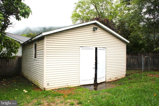 view of outbuilding featuring a yard