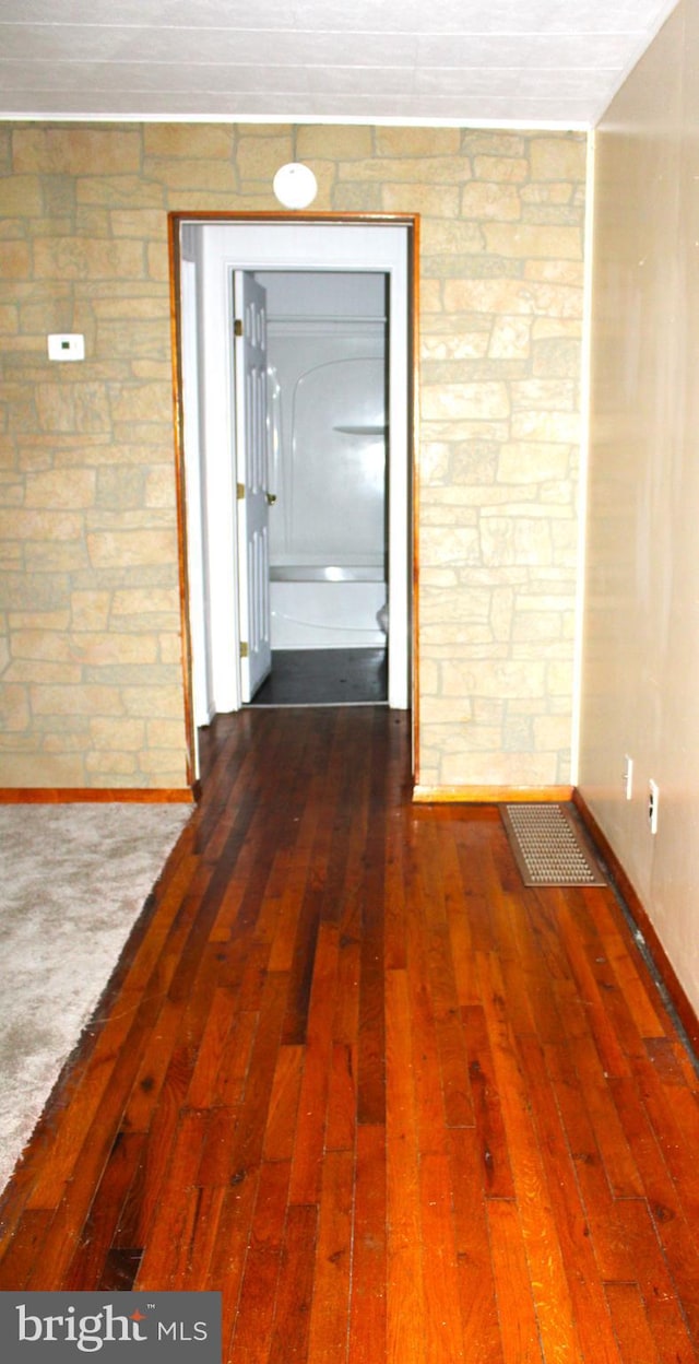 corridor with dark hardwood / wood-style floors