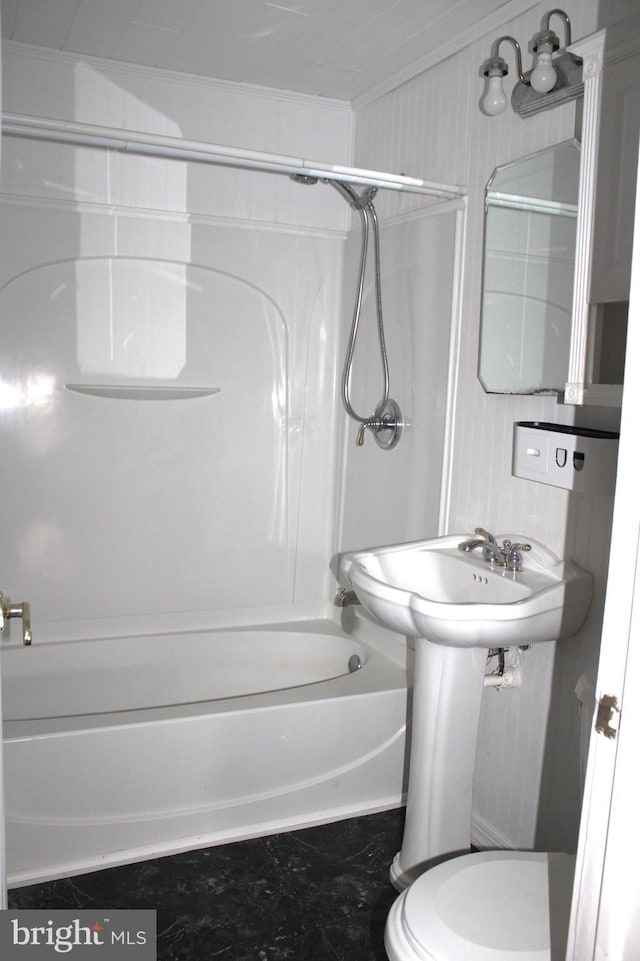 bathroom featuring toilet, bathing tub / shower combination, and crown molding