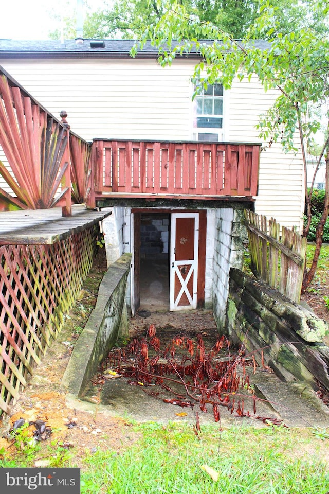 rear view of property featuring a wooden deck